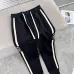 Stylish Loewe Black Track Pants With Contrast Stripes And Branding For Elevated Casual Wear #A25072