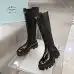Prada's Sleek Black Knee-High Boots Featuring Glossy Texture and Iconic Logo #A54584
