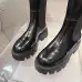 Prada's Sleek Black Knee-High Boots Featuring Glossy Texture and Iconic Logo #A54584
